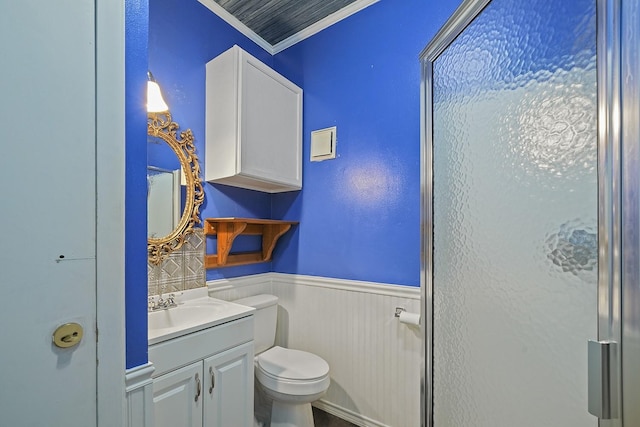 bathroom featuring vanity, toilet, and ornamental molding