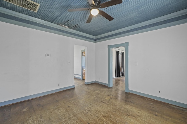 spare room featuring hardwood / wood-style floors, a raised ceiling, ceiling fan, and a baseboard heating unit