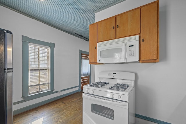 kitchen with hardwood / wood-style flooring and white appliances