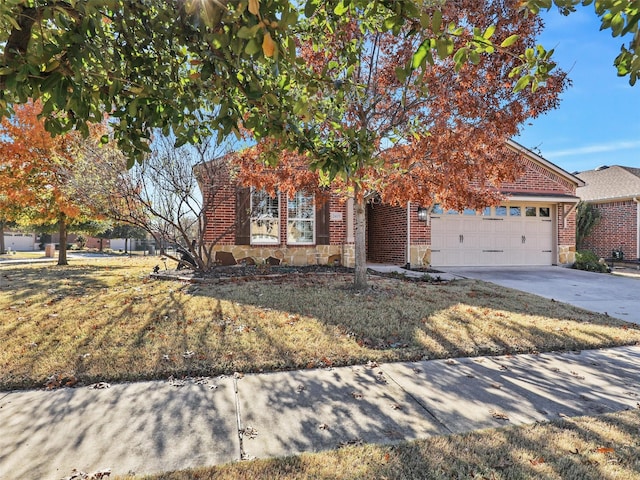 view of property hidden behind natural elements with a front yard and a garage