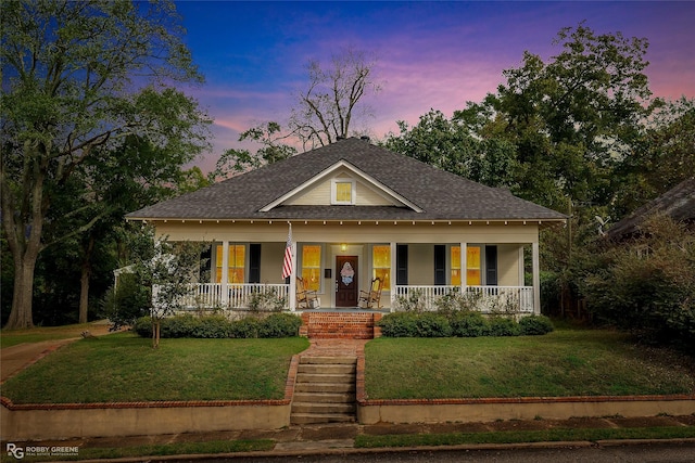 view of front facade with a yard and covered porch