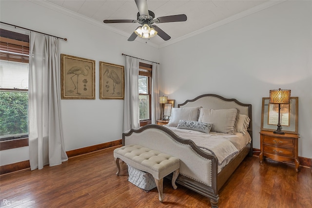 bedroom featuring ceiling fan, baseboards, crown molding, and wood finished floors