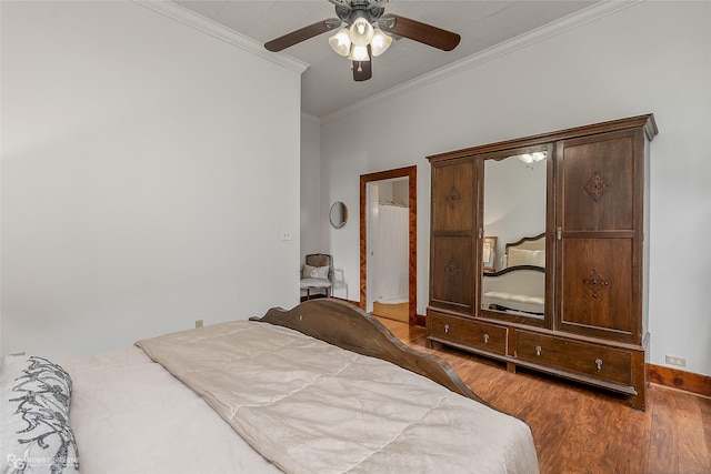 bedroom with baseboards, crown molding, a ceiling fan, and wood finished floors