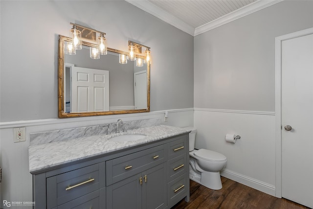 bathroom featuring ornamental molding, vanity, toilet, and wood finished floors