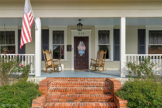 view of exterior entry featuring a porch