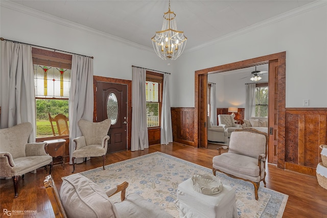 sitting room featuring a wainscoted wall, wood finished floors, and a healthy amount of sunlight