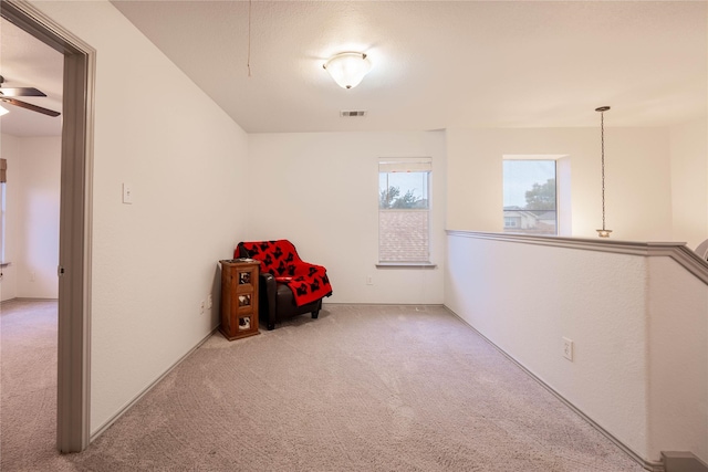 interior space with ceiling fan