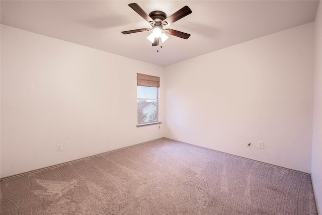 empty room with ceiling fan and carpet floors