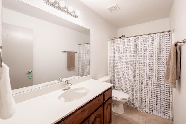 bathroom featuring tile patterned floors, vanity, a shower with shower curtain, and toilet