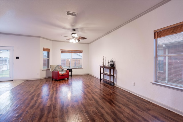 unfurnished room with ceiling fan, dark hardwood / wood-style flooring, and ornamental molding