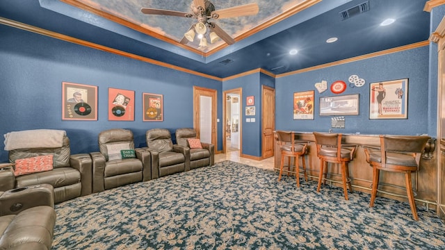 cinema with crown molding, indoor bar, carpet flooring, and ceiling fan