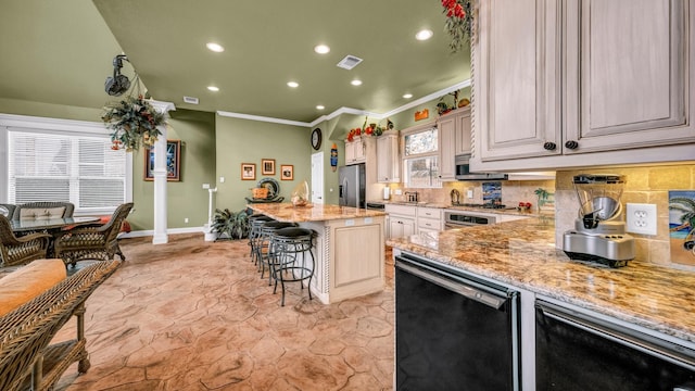 kitchen with backsplash, a kitchen bar, a center island, light stone counters, and stainless steel appliances