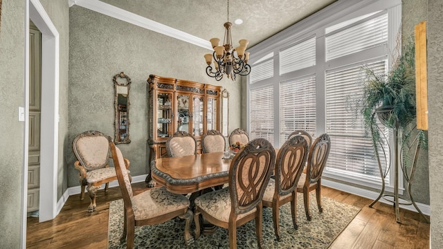 dining room featuring an inviting chandelier, ornamental molding, and wood-type flooring