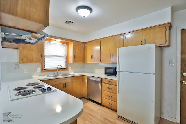 kitchen with white appliances, sink, range hood, and light hardwood / wood-style flooring