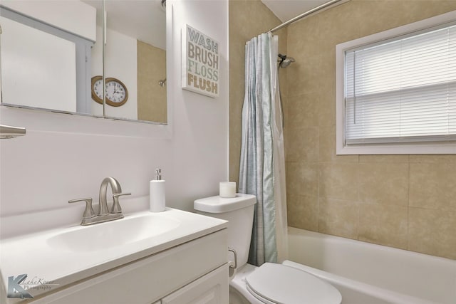 full bathroom featuring shower / bath combo, vanity, and toilet