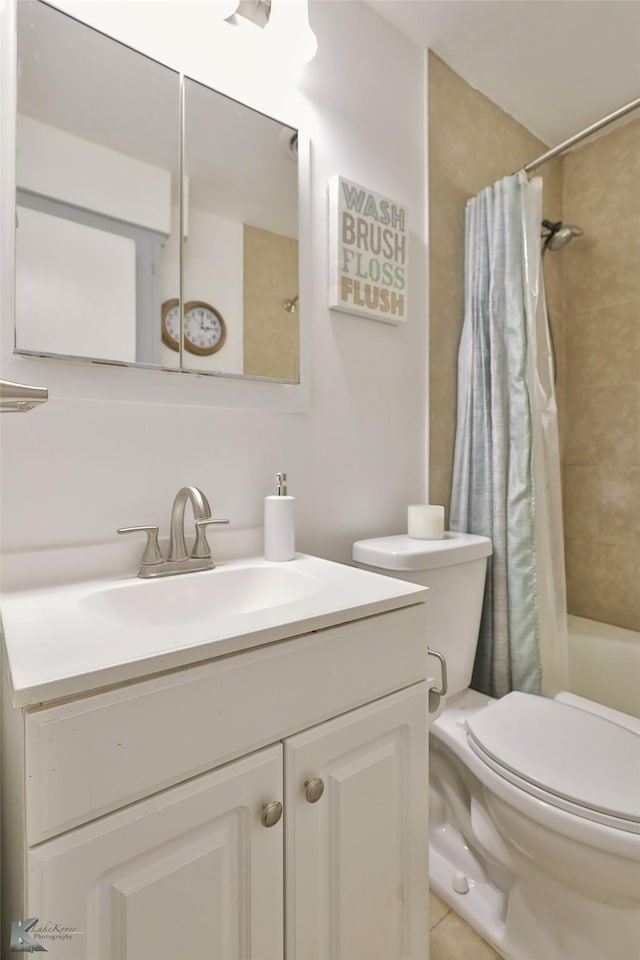 full bathroom featuring tile patterned flooring, vanity, toilet, and shower / tub combo with curtain