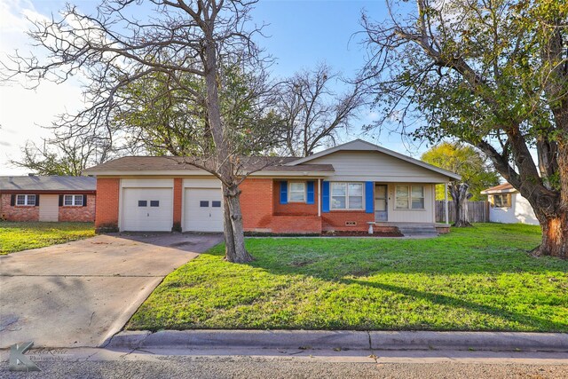 ranch-style home featuring a garage and a front lawn