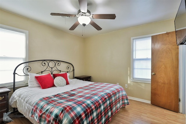 bedroom with light hardwood / wood-style flooring and ceiling fan