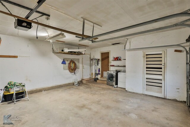 garage featuring separate washer and dryer and a garage door opener