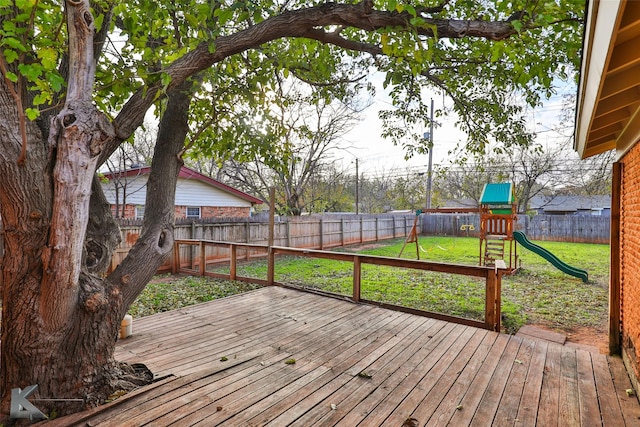 wooden deck with a yard and a playground