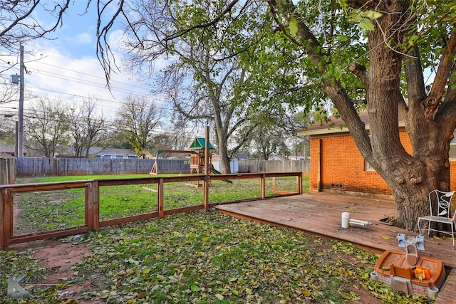 view of yard with a deck and a playground