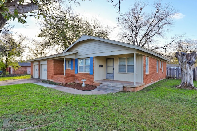 view of front of house with covered porch, a garage, and a front lawn