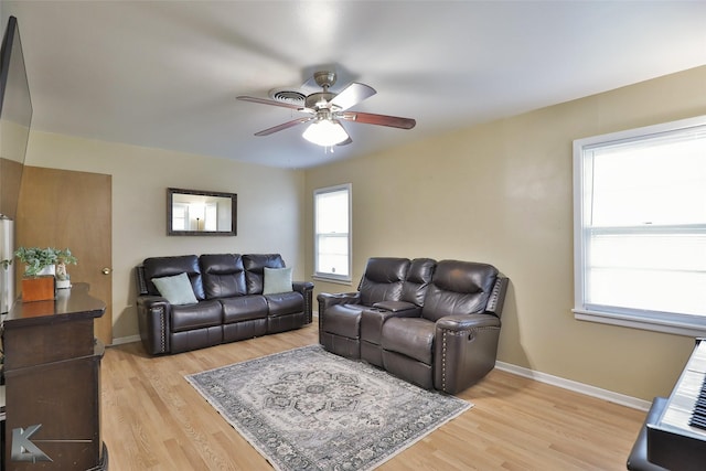 living room with ceiling fan and light wood-type flooring