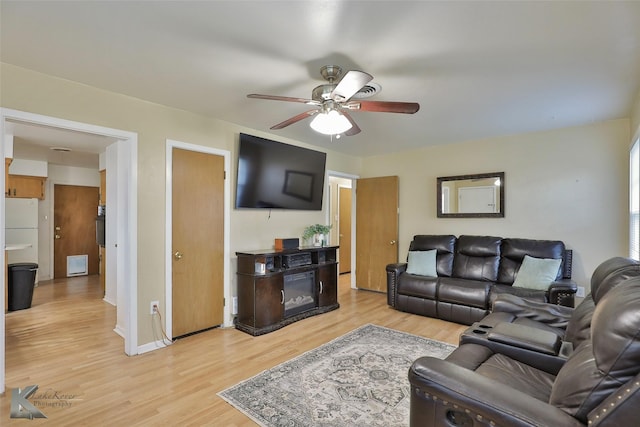 living room featuring ceiling fan and light wood-type flooring