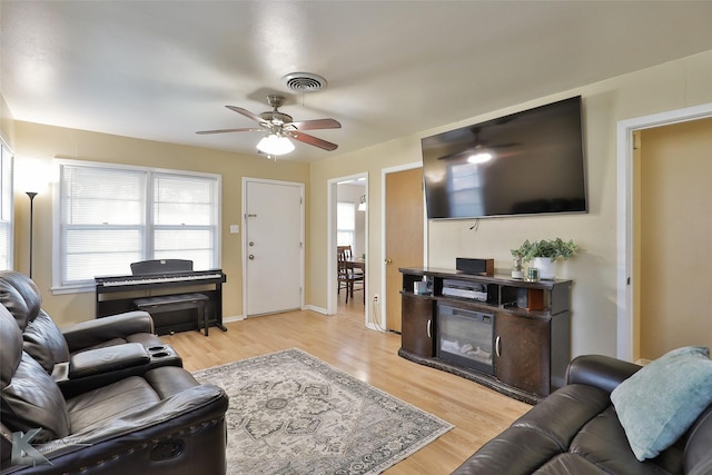 living room featuring ceiling fan and light wood-type flooring