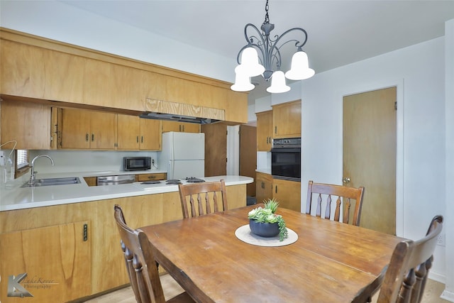 dining room with sink and a chandelier