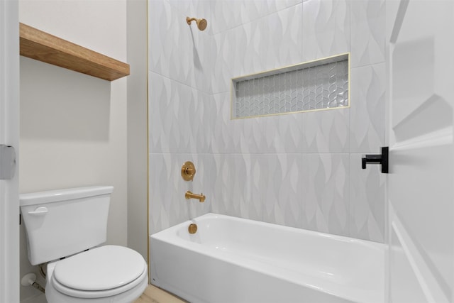 bathroom featuring tiled shower / bath and toilet