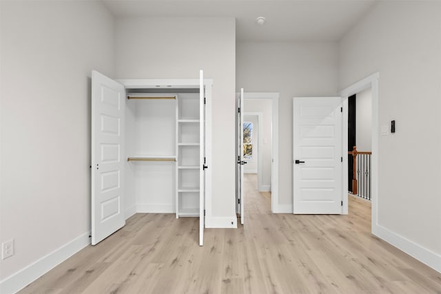 unfurnished bedroom with a closet and light hardwood / wood-style flooring