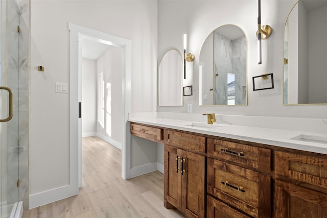 bathroom featuring vanity, wood-type flooring, and walk in shower