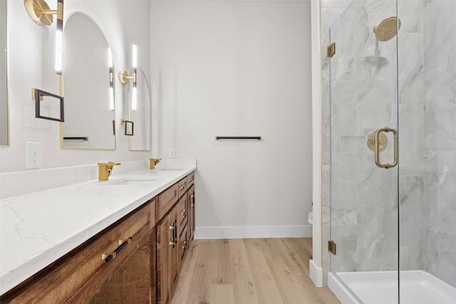 bathroom featuring vanity, toilet, an enclosed shower, and hardwood / wood-style floors