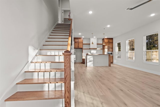 stairs with hardwood / wood-style flooring