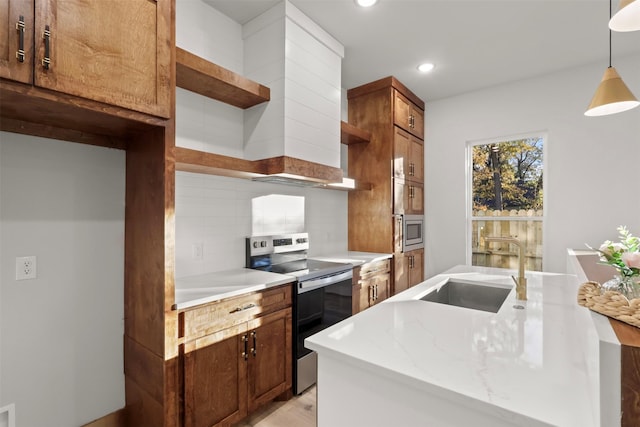 kitchen with sink, hanging light fixtures, stainless steel appliances, tasteful backsplash, and light stone countertops