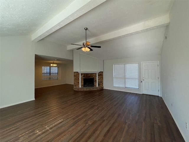 unfurnished living room featuring dark wood-type flooring, lofted ceiling with beams, ceiling fan, a textured ceiling, and a fireplace