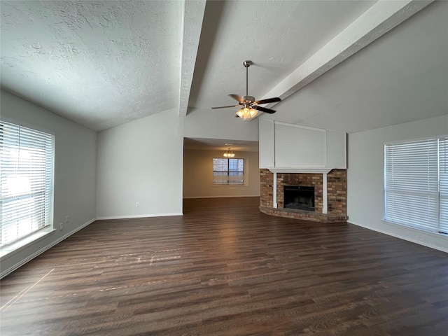 unfurnished living room featuring a fireplace, ceiling fan, dark hardwood / wood-style flooring, and a textured ceiling