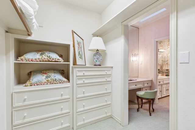 walk in closet featuring light colored carpet