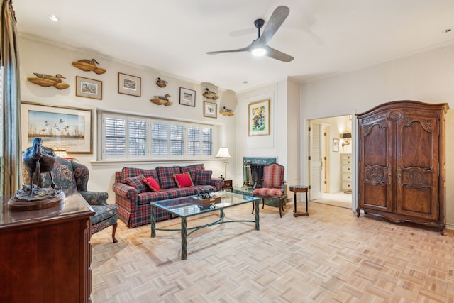 living room with light parquet flooring, ceiling fan, and ornamental molding