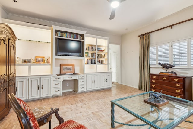 living room with crown molding, light parquet flooring, built in desk, and ceiling fan