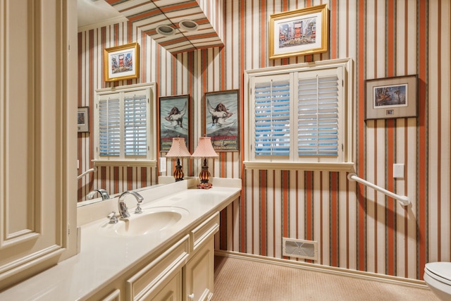 bathroom featuring vanity and toilet