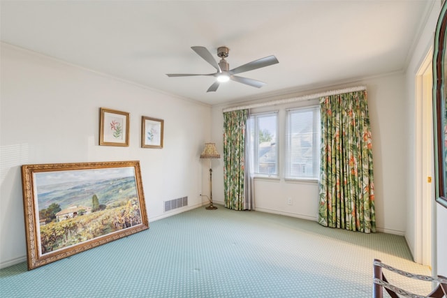 interior space featuring carpet, ceiling fan, and crown molding