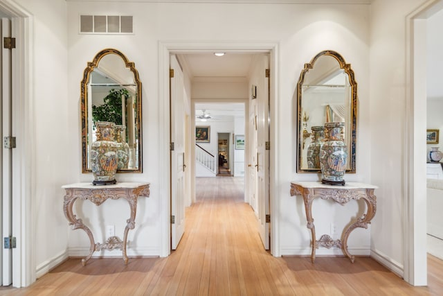 hall featuring crown molding and light wood-type flooring