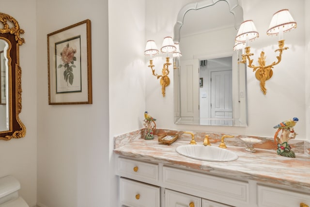 bathroom featuring vanity and toilet