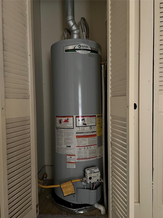 utility room featuring water heater