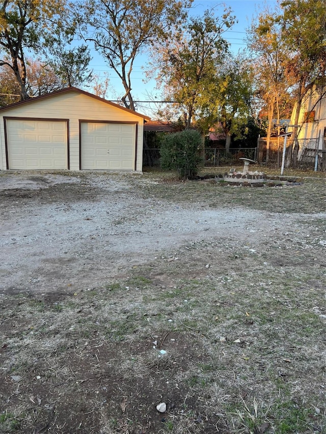 view of yard featuring a garage and an outdoor structure