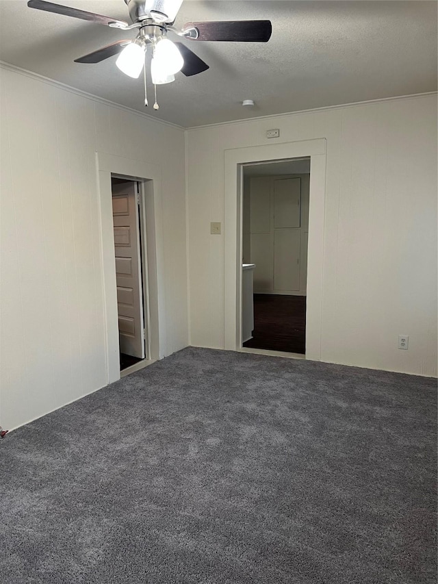 empty room with carpet flooring, a textured ceiling, ceiling fan, and ornamental molding