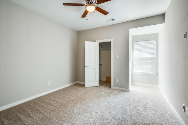 unfurnished bedroom featuring ceiling fan and light carpet