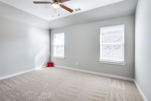 spare room with vaulted ceiling, ceiling fan, and carpet